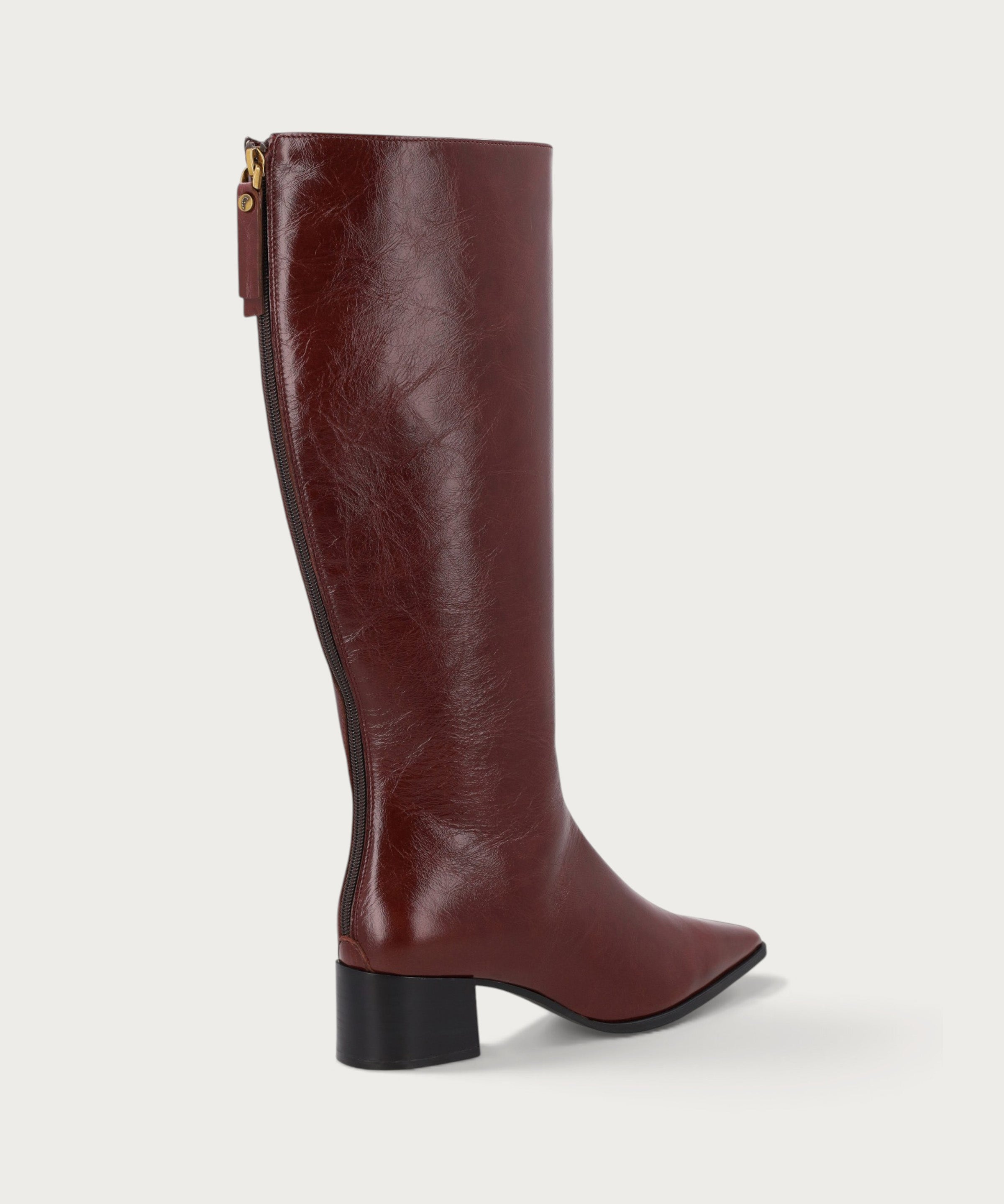 Knee-high heeled boots in burgundy polished leather